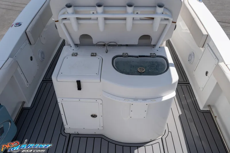 Slide: The Image of 2021 Sea Hunt ULTRA 305 boat deck with storage and livewell. - 18
