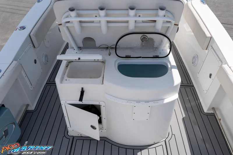 Slide: The Image of 2021 Sea Hunt ULTRA 305 boat interior with fishing rod holders and storage compartments. - 19