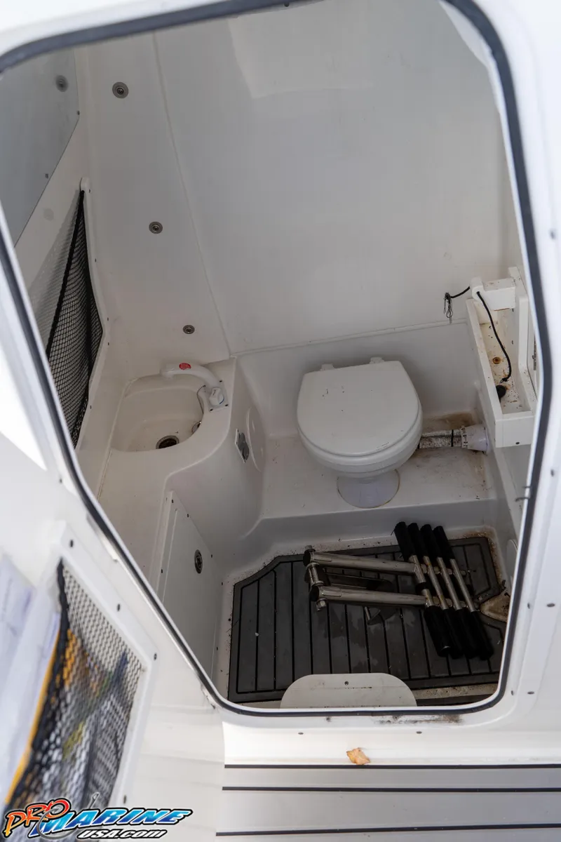 Slide: The Image of 2021 Sea Hunt ULTRA 305 boat interior with toilet and sink. - 20