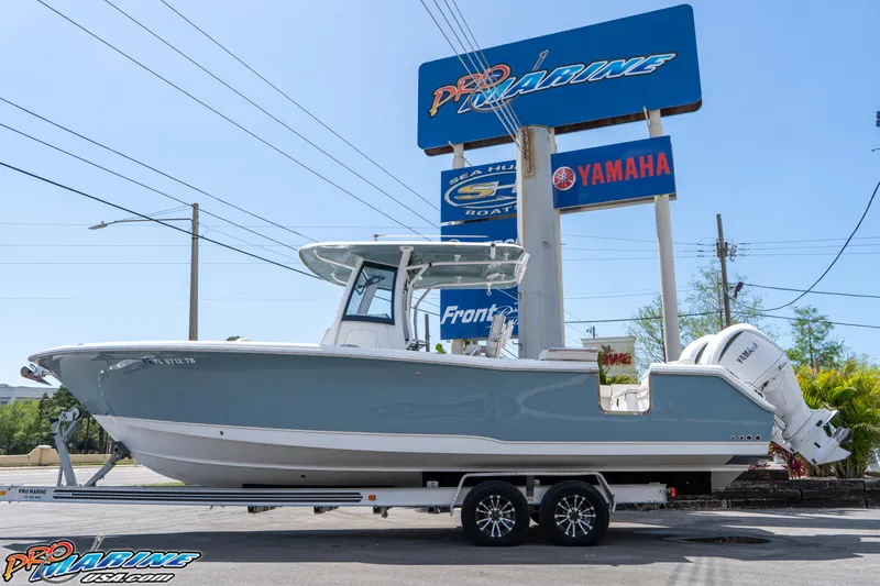 Slide: The Image of 2021 Sea Hunt ULTRA 305 boat on trailer, displayed at dealership with Yamaha signage. - 6