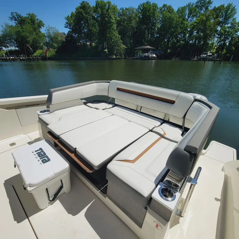 Slide: The Image of 2021 Tiara Yachts 38 LS with luxurious seating, docked by a serene lake. - 16