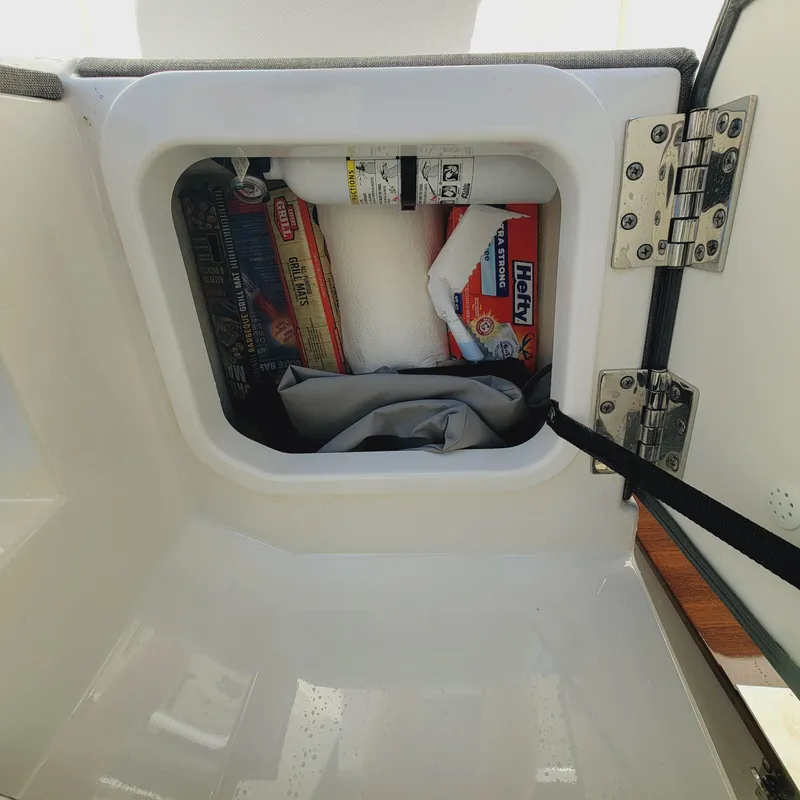 Slide: The Image of Storage compartment on a 2021 Tiara Yachts 38 LS, containing various items. - 44