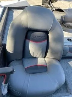 Slide: The Image of 2025 Tracker Pro Team 175 boat seat with gray upholstery and red accents. - 4