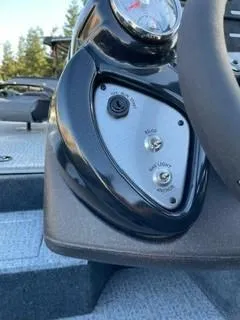 Slide: The Image of Control panel of 2025 Tracker Pro Team 175 boat with switches and steering wheel. - 6