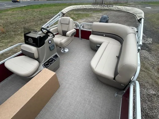 Slide: The Image of 2025 Sun Tracker Bass Buggy 16 XL Select pontoon boat interior with beige seating. - 12