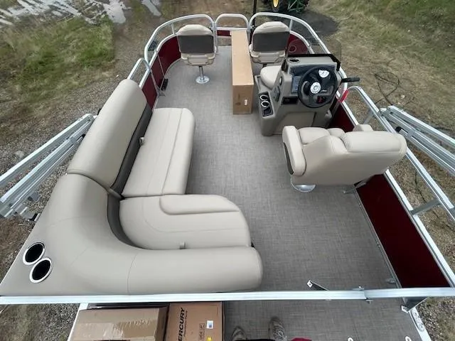 Slide: The Image of 2025 Sun Tracker Bass Buggy 16 XL Select pontoon boat interior with beige seating and steering console. - 13