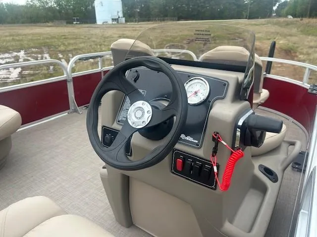 Slide: The Image of 2025 Sun Tracker Bass Buggy 16 XL Select boat console with steering wheel and controls. - 14