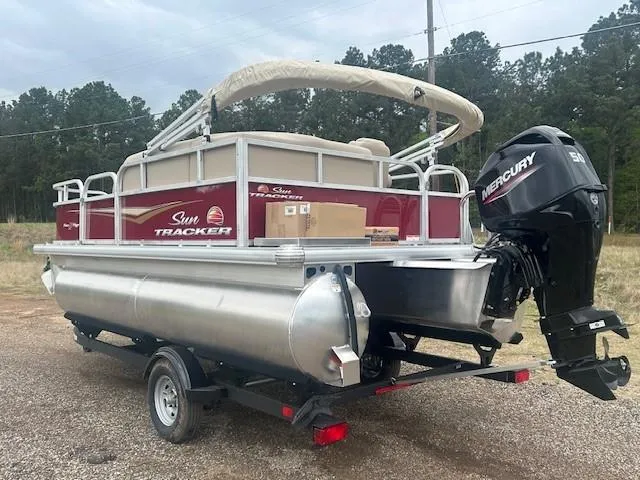 Slide: The Image of 2025 Sun Tracker Bass Buggy 16 XL Select pontoon boat with Mercury engine on trailer. - 8