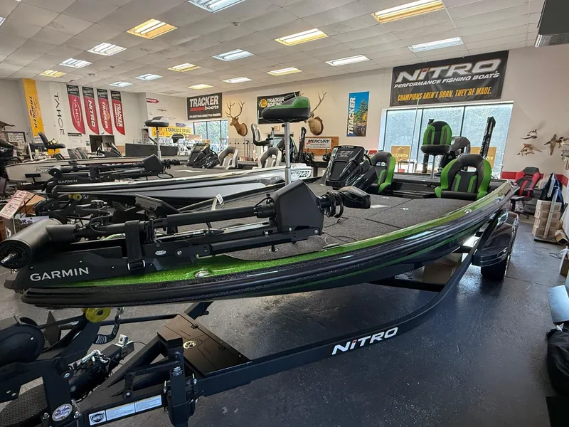 Slide: The Image of 2025 Nitro Z21 XL Pro fishing boat in showroom, featuring Garmin equipment. - 1