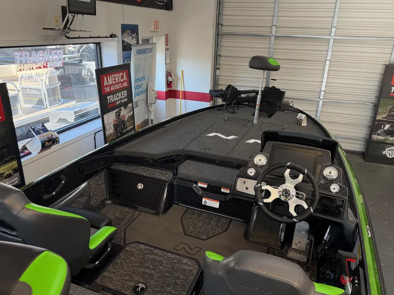 Slide: The Image of 2025 Nitro Z21 XL Pro boat interior with modern dashboard and seating in showroom. - 2