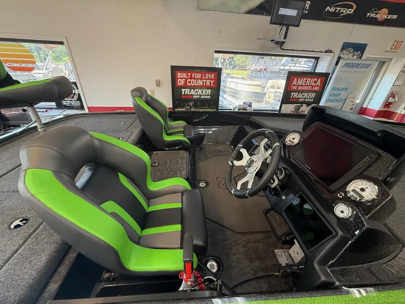 Slide: The Image of 2025 Nitro Z21 XL Pro boat interior with green and black seats, modern dashboard, and steering wheel. - 3