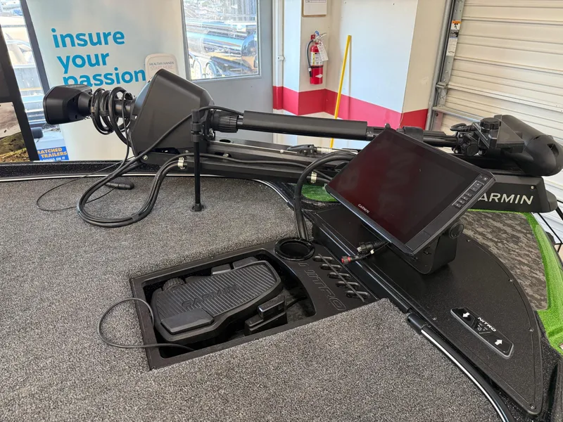 Slide: The Image of 2025 Nitro Z21 XL Pro boat with Garmin electronics and trolling motor in a showroom. - 4