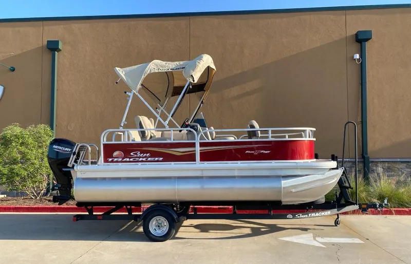 Slide: The Image of 2025 Sun Tracker Bass Buggy 16 XL Select pontoon boat with canopy on trailer. - 3
