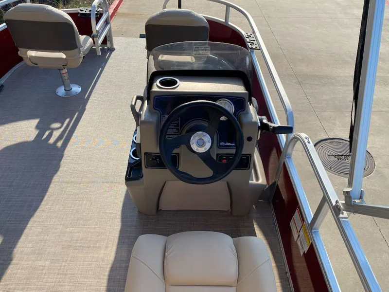 Slide: The Image of 2025 Sun Tracker Bass Buggy 16 XL Select pontoon boat interior with steering console. - 5