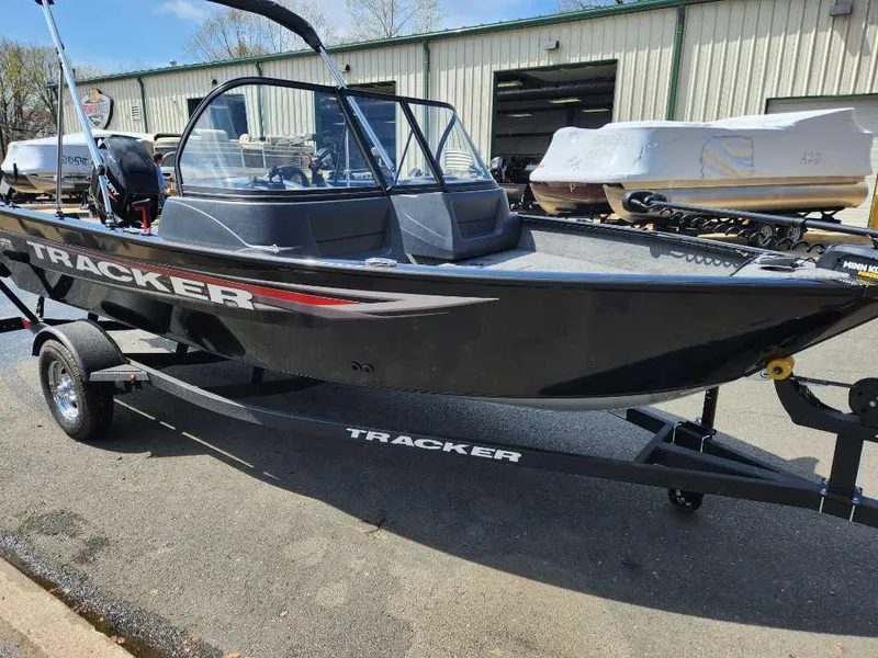 Slide: The Image of 2025 Tracker Pro Guide V-16 WT boat on trailer, parked outdoors. - 6