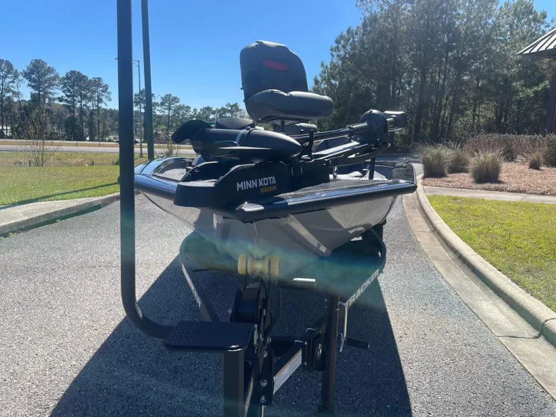 Slide: The Image of 2025 Tracker Pro Team 175 boat with Minn Kota motor on a sunny day. - 2