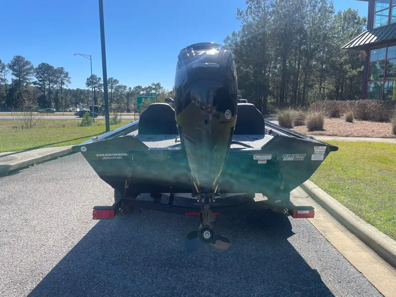 Slide: The Image of 2025 Tracker Pro Team 175 boat, rear view, parked outdoors on a sunny day. - 7