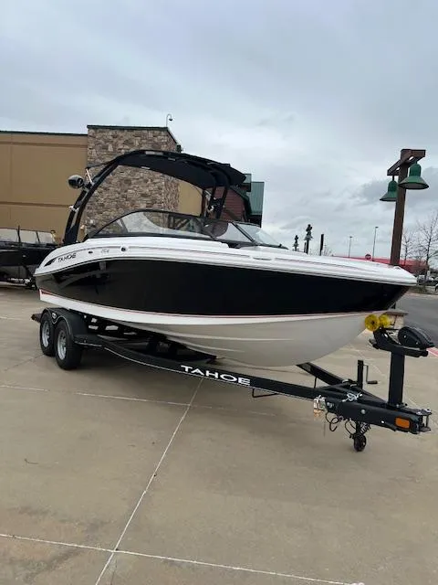 Slide: The Image of 2024 Tahoe 210 S boat on trailer, parked outdoors, overcast sky. - 1