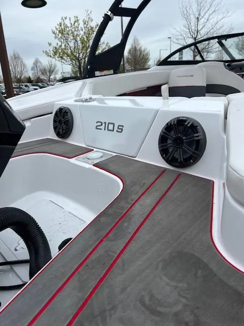 Slide: The Image of 2024 Tahoe 210 S boat interior with speakers and sleek design. - 10