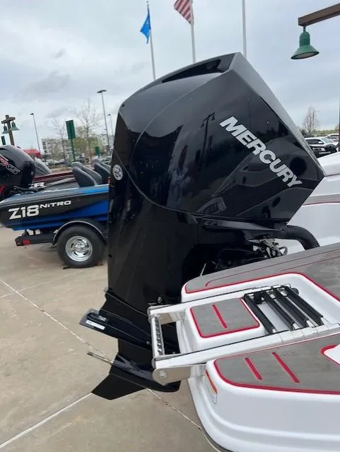 Slide: The Image of 2024 Tahoe 210 S boat with Mercury outboard motor, docked with ladder visible. - 11