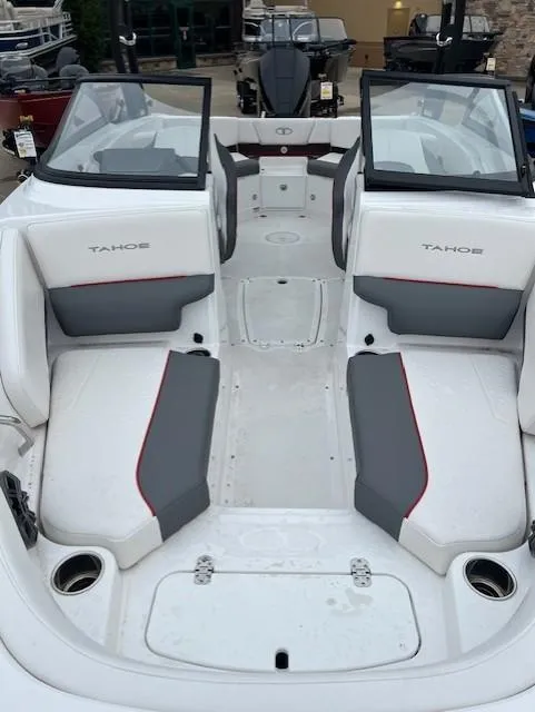 Slide: The Image of 2024 Tahoe 210 S boat interior with dual consoles and cushioned seating. - 13