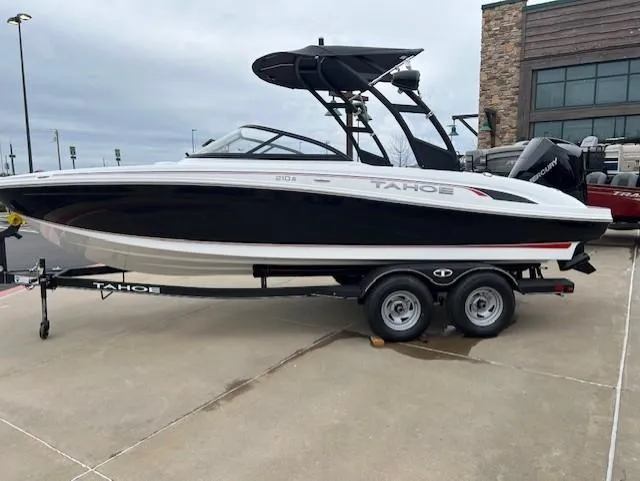 Slide: The Image of 2024 Tahoe 210 S boat on trailer, black and white design, parked outdoors. - 3