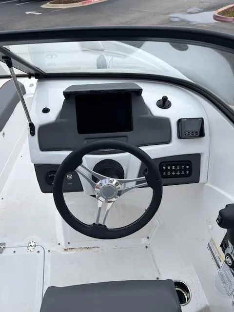 Slide: The Image of 2024 Tahoe 210 S boat dashboard with steering wheel and control panel. - 6