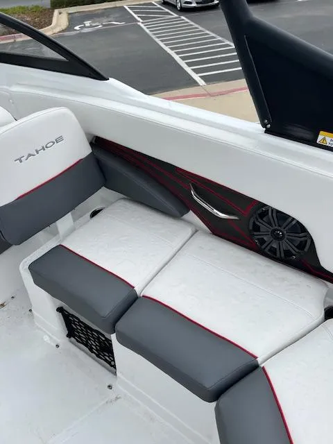 Slide: The Image of 2024 Tahoe 210 S boat interior with gray and white seating, red accents, and speaker detail. - 9