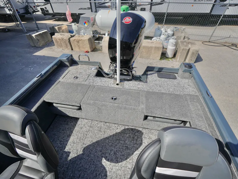 Slide: The Image of 2025 Ranger VS1782SC Reata boat interior with motor, gray seating, and carpeted deck. - 13