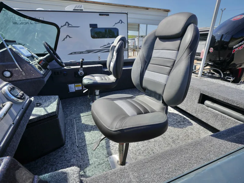 Slide: The Image of 2025 Ranger VS1782SC Reata boat interior with two cushioned seats and dashboard. - 7