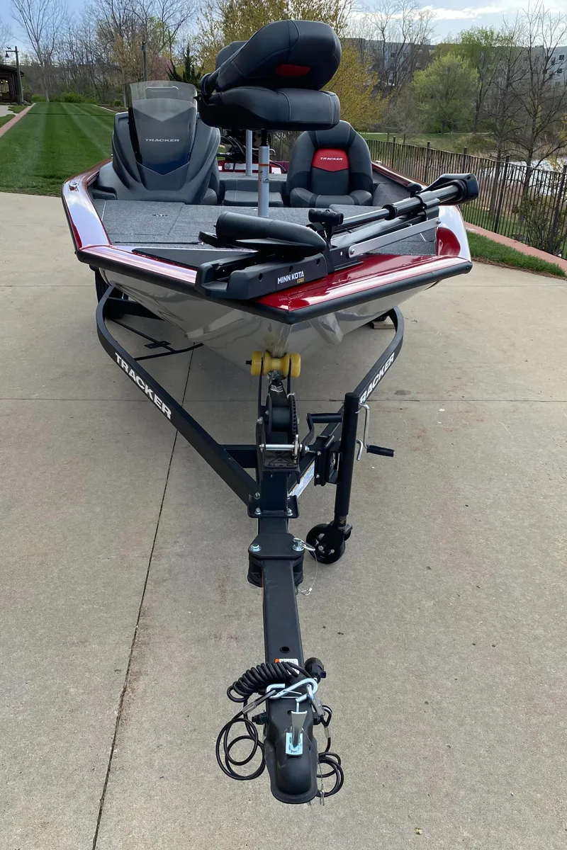Slide: The Image of 2025 Tracker Pro Team 175 boat on trailer, parked on concrete driveway. - 2