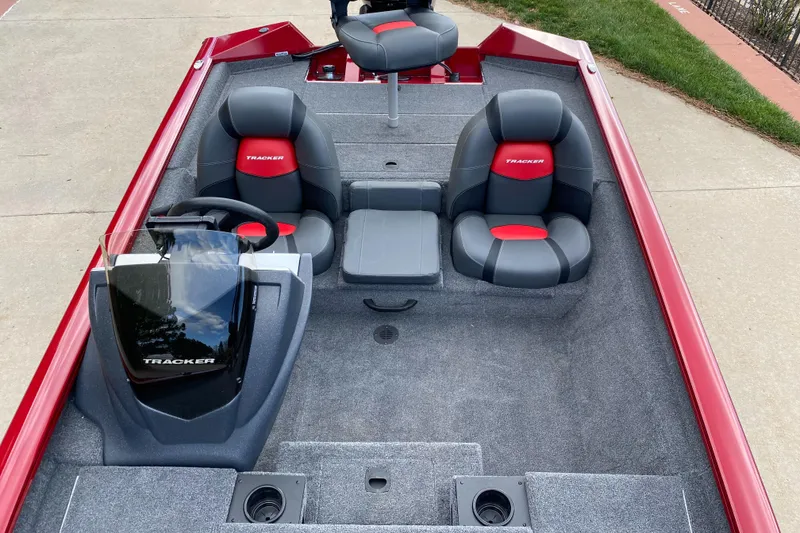 Slide: The Image of 2025 Tracker Pro Team 175 boat interior with red and gray seating, steering console, and carpeted floor. - 4