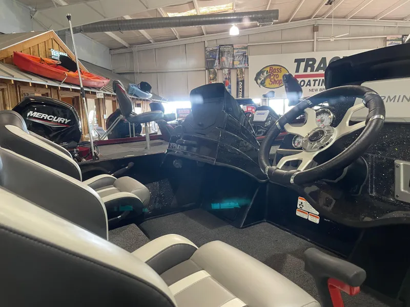 Slide: The Image of 2025 Nitro Z18 Pro boat interior with steering wheel and seating in showroom. - 9