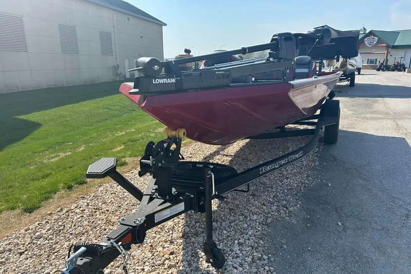 Slide: The Image of 2025 Ranger RT178 boat on trailer, parked outdoors, featuring a red hull and Lowrance equipment. - 1