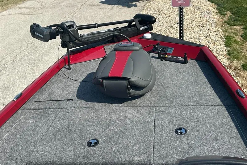 Slide: The Image of 2025 Ranger RT178 boat deck with trolling motor and seat, parked on gravel. - 3