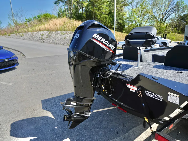 Slide: The Image of 2025 Tracker Pro Team 175 with Mercury outboard motor in a parking lot. - 16