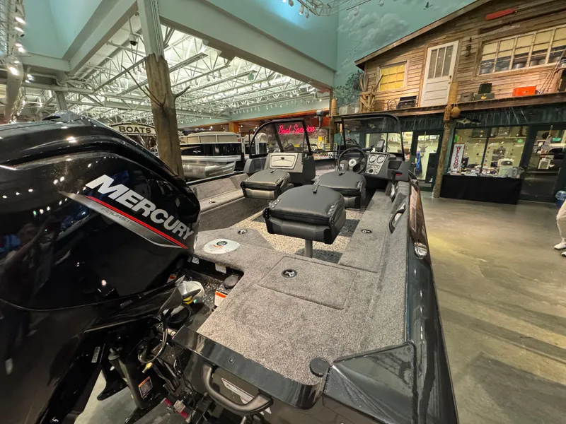Slide: The Image of 2025 Tracker Pro Guide V-16 WT boat with Mercury engine in showroom. - 3