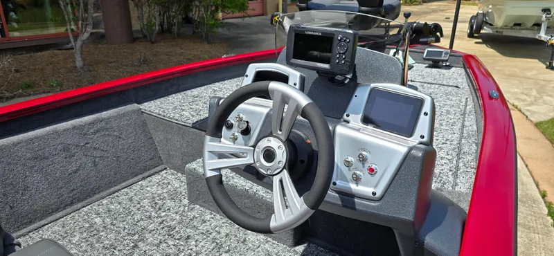 Slide: The Image of 2025 Tracker Pro Team 175 boat dashboard with steering wheel and electronic displays. - 3