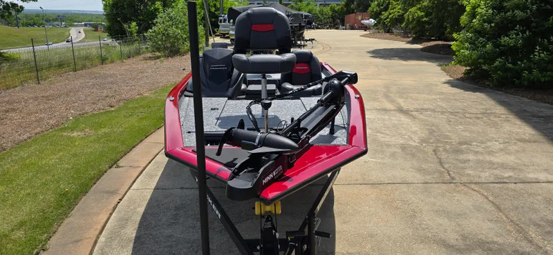 Slide: The Image of 2025 Tracker Pro Team 175 boat, red and black, parked on a driveway. - 4