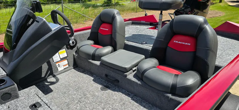 Slide: The Image of 2025 Tracker Pro Team 175 boat interior with black and red seats, steering console, and carpeted floor. - 6