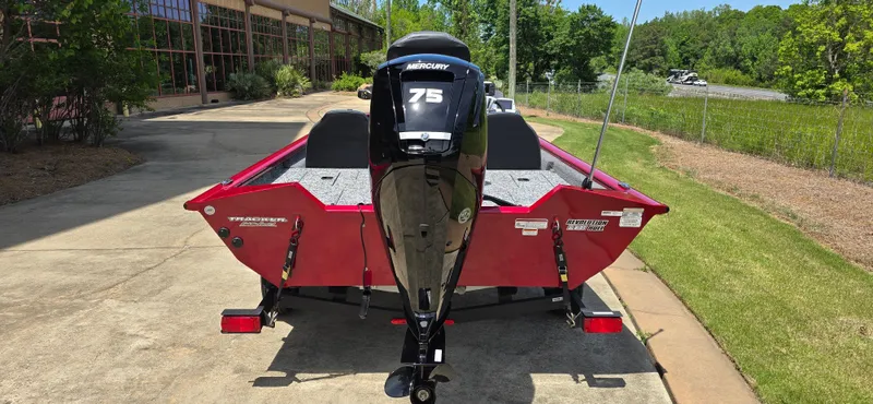 Slide: The Image of 2025 Tracker Pro Team 175 boat with Mercury 75 engine, parked on a sunny driveway. - 8