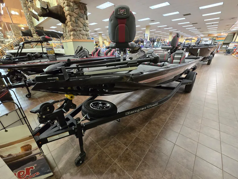 Slide: The Image of 2025 Ranger RT178 boat displayed indoors on a showroom floor. - 0