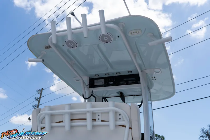 Slide: The Image of 2022 Sea Hunt BX 25 FS boat with T-top and rod holders under a blue sky. - 11