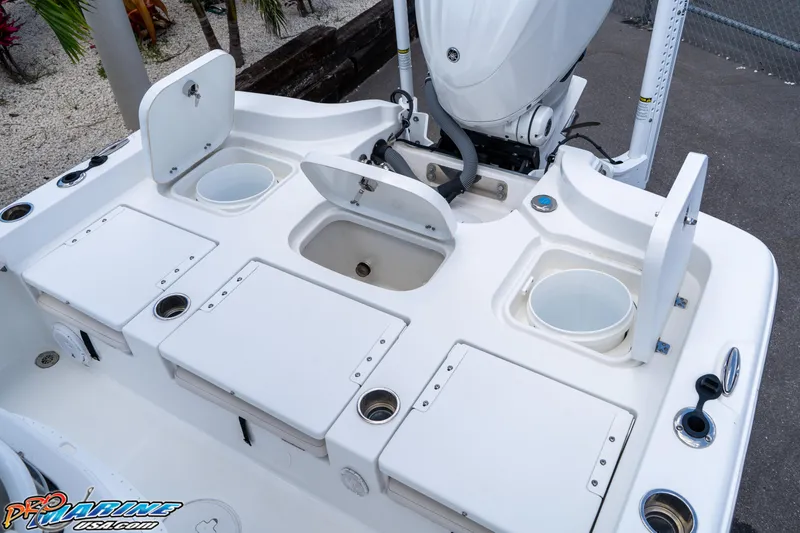 Slide: The Image of 2022 Sea Hunt BX 25 FS boat deck with storage compartments and motor. - 17