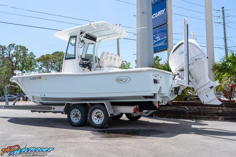 Slide: The Image of 2022 Sea Hunt BX 25 FS boat on trailer, displayed outdoors. - 7