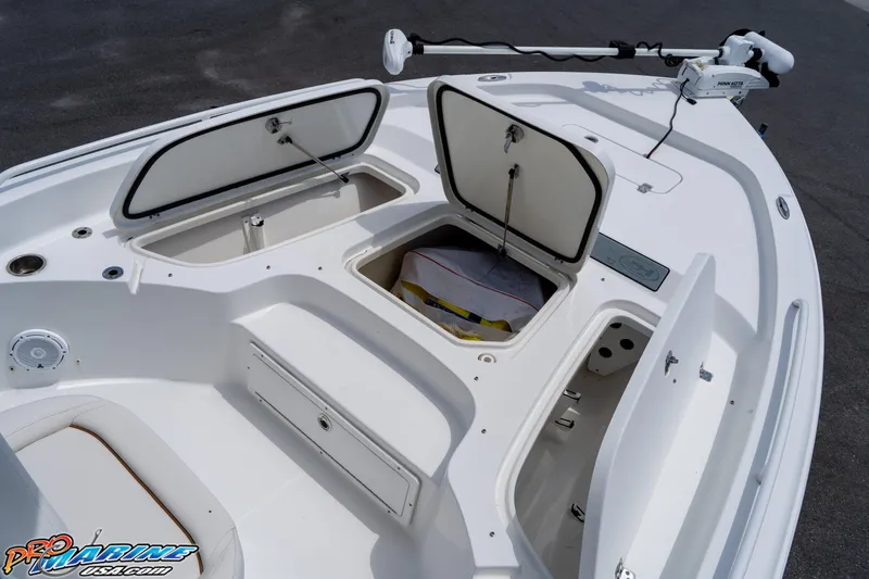 Slide: The Image of 2022 Sea Hunt BX 25 FS boat with open storage compartments and trolling motor. - 8