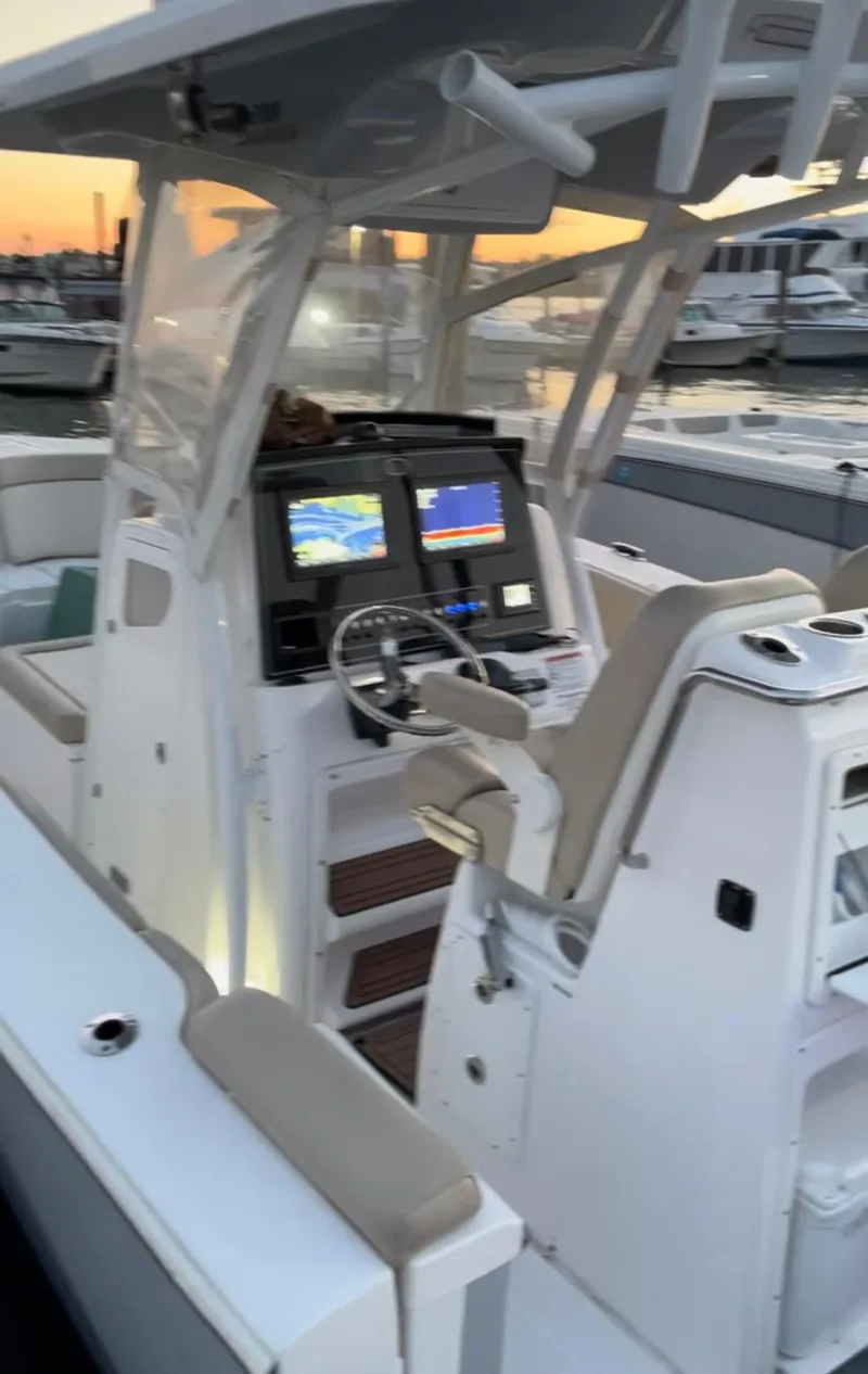 Slide: The Image of 2017 Sea Fox 288 Commander boat interior with dual screens at sunset. - 17
