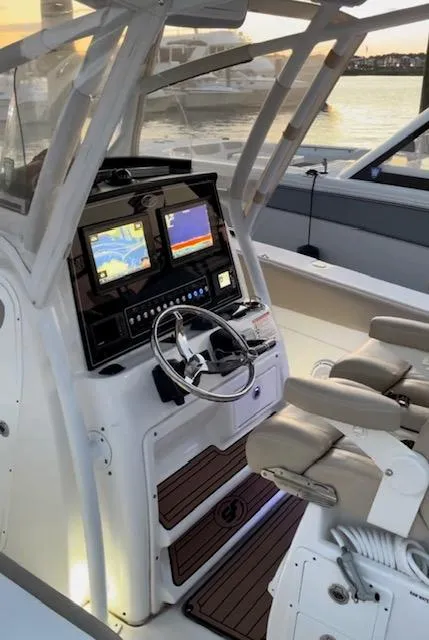 Slide: The Image of 2017 Sea Fox 288 Commander boat cockpit with dual displays and steering wheel at sunset. - 19