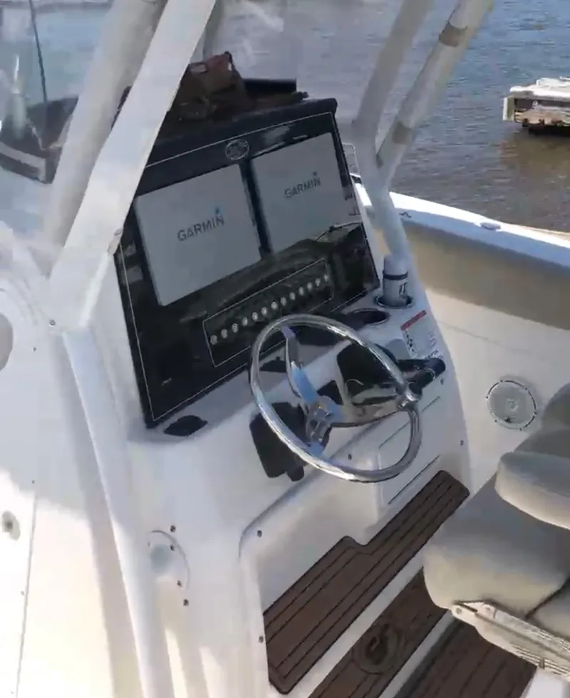Slide: The Image of 2017 Sea Fox 288 Commander helm with Garmin displays and steering wheel. - 24