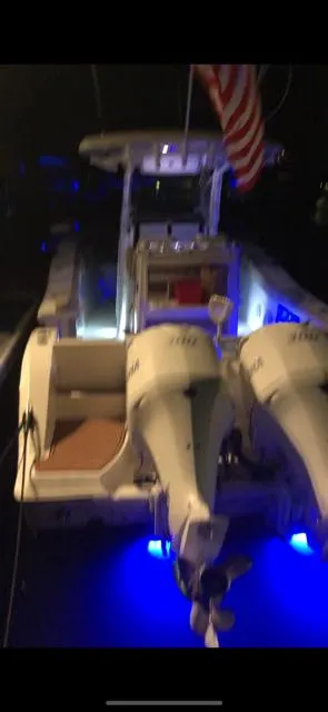 Slide: The Image of 2017 Sea Fox 288 Commander boat with dual engines, illuminated at night. - 30